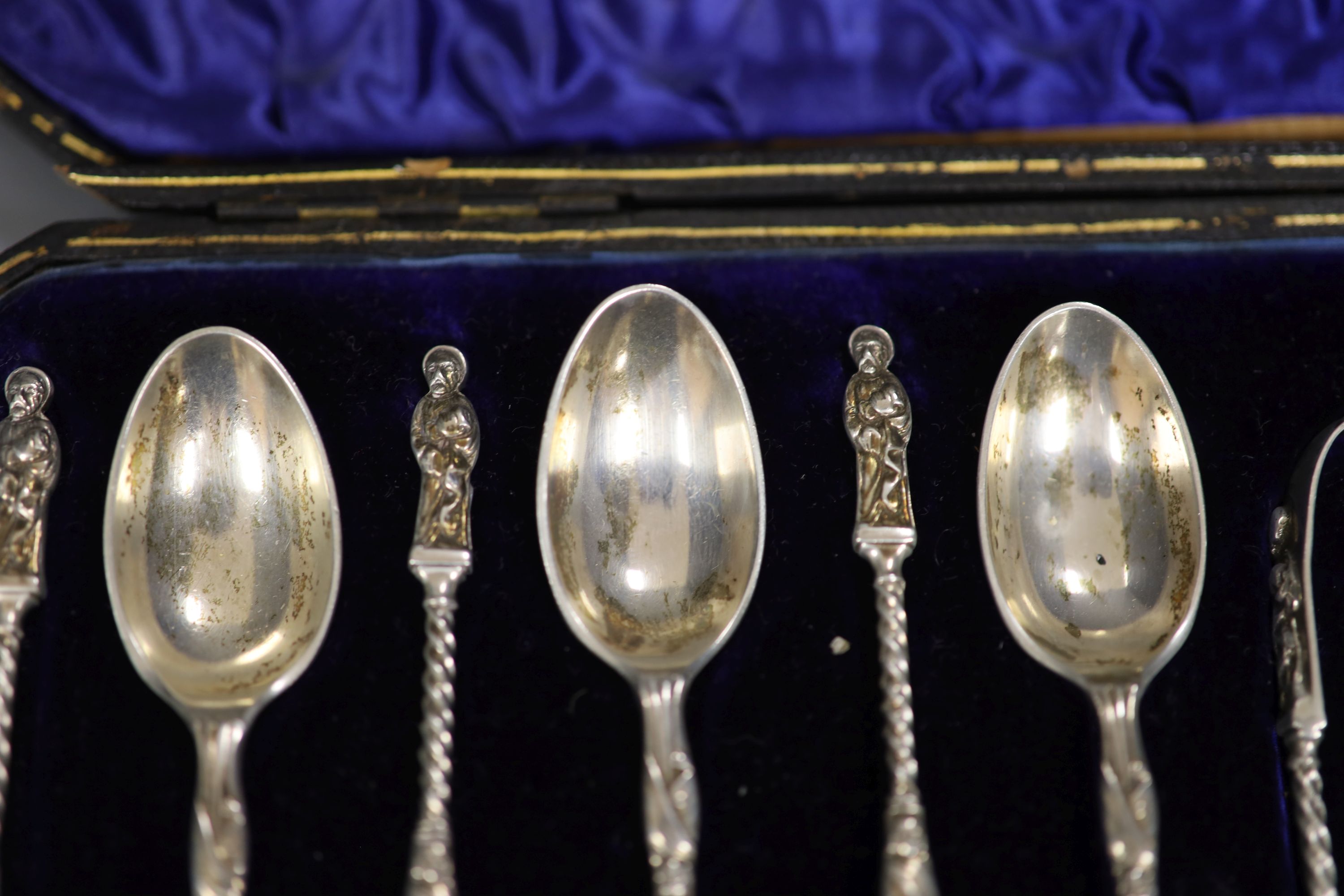 A late Victorian cased set of twelve silver apostle teaspoons and tongs, William Hutton & Sons, London, 1900.
